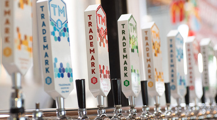 Row of many colorful TMB tap handles 