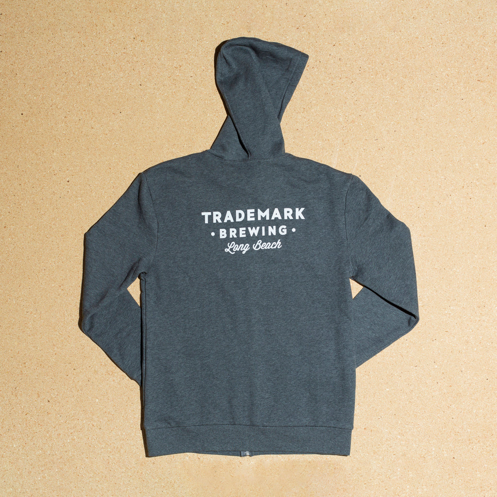 Photo of back side of hoodie with large trademark brewing text logo