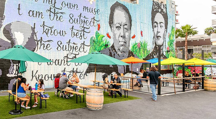 Trademark Brewing outdoor beer garden and lawn with colorful umbrellas and mural art 