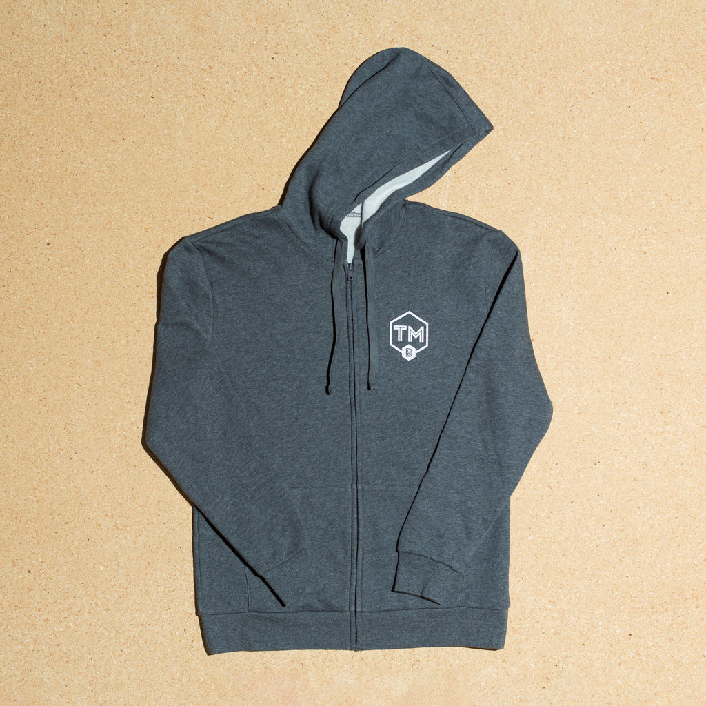 Photo of gray hoodie with small TMb shield logo - front side